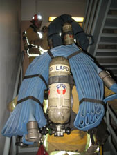 Fire crews carry the heavey gear into the tower